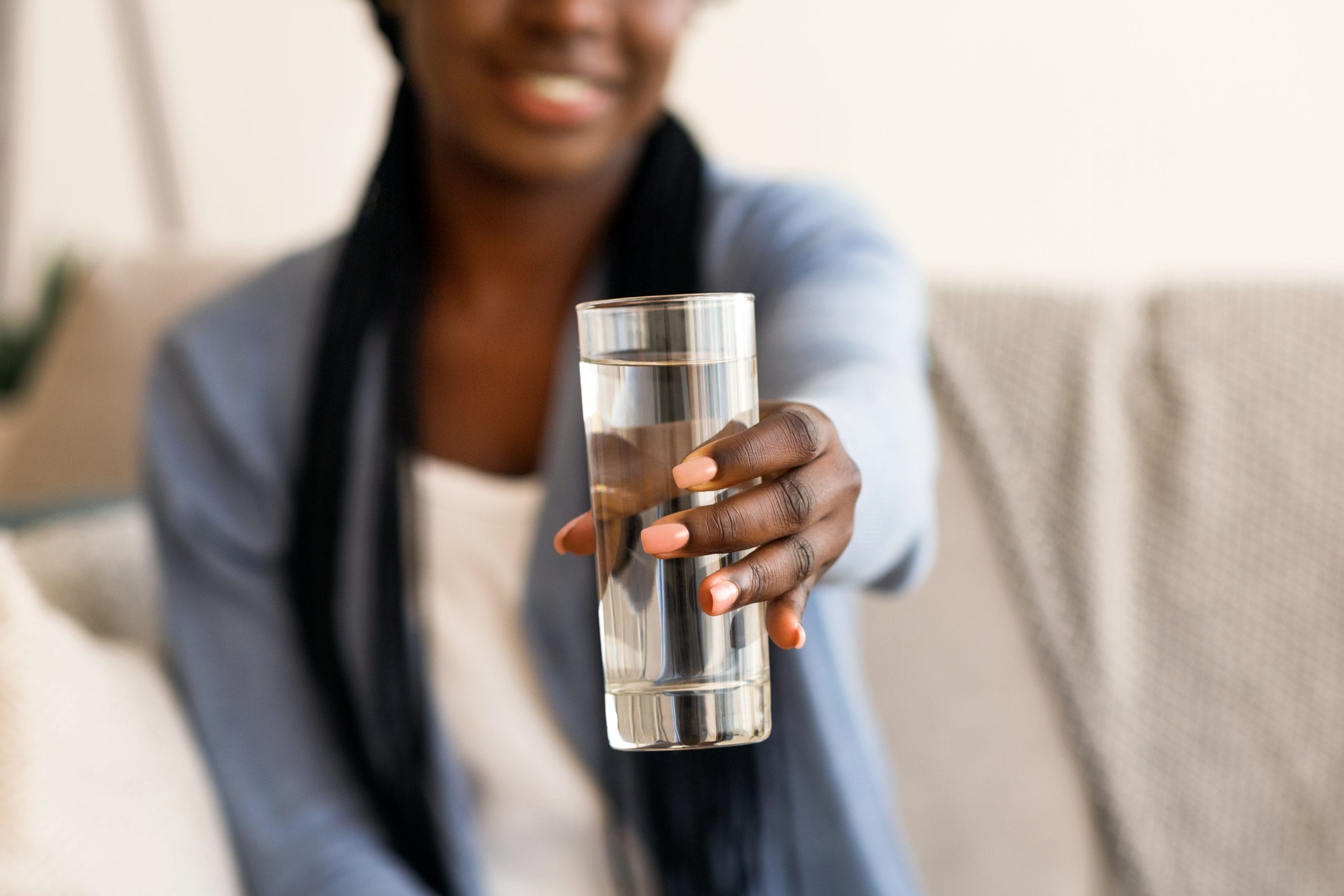 Woman Holding Clear Glass of Water for Free Testing Promotion
